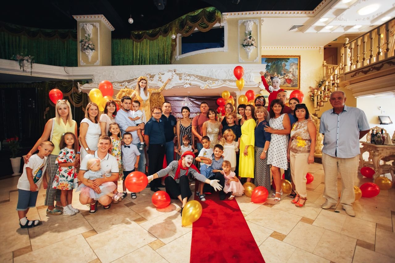 The Art of Drawing Readers In: Your attractive post title goes here Group of people enjoying a festive indoor party with clowns and colorful balloons.
